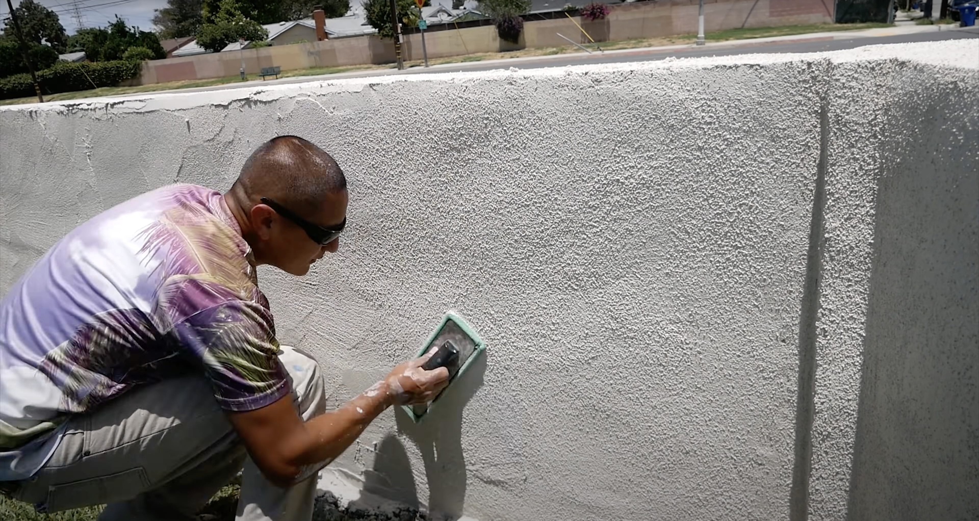 Professional concrete contractor applying finishing techniques to large commercial concrete slab in Henderson, KY