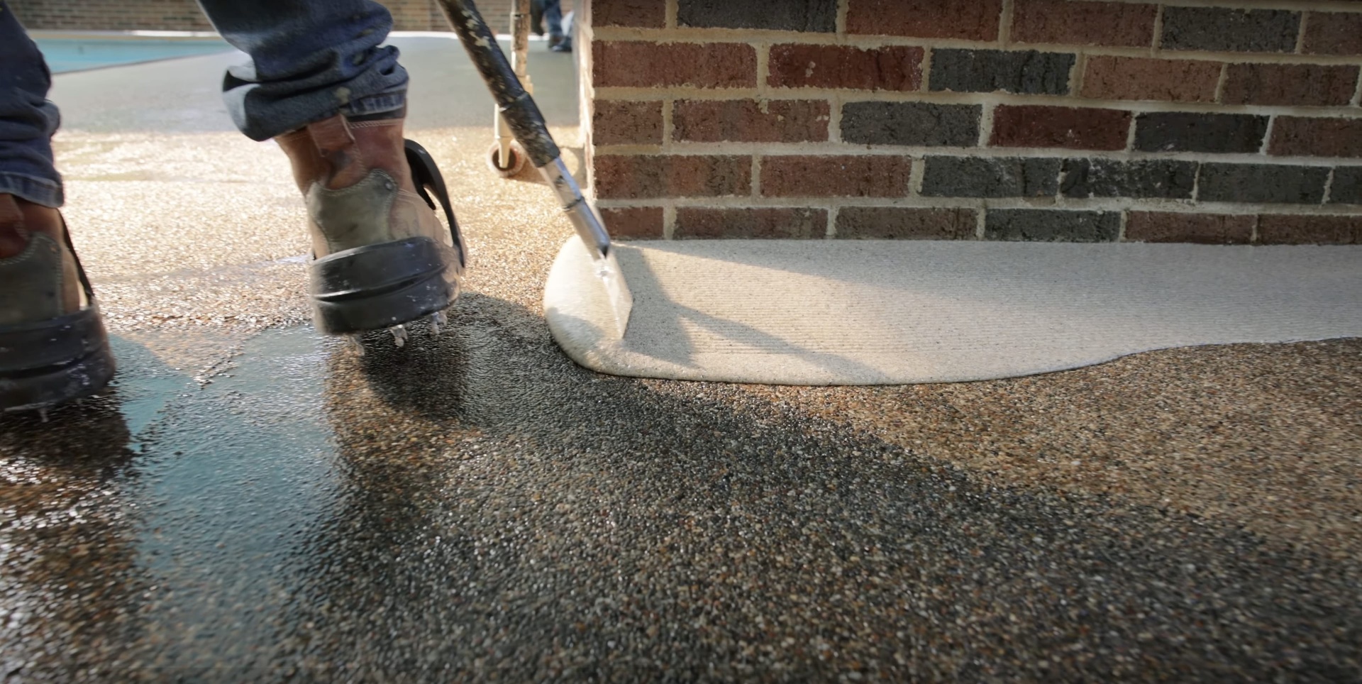 Professional concrete finishing work showing smooth trowel technique on residential driveway in Henderson, KY